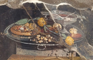 A painting on a wall in Pompeii depicts what appears to be pizza, along with friet and a goblet of wine.