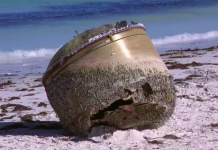 Mystery Object Washes Up on Australian Beach A cylindrical object, appearing to be made of metal, sits where it washed up on an Australian beach.